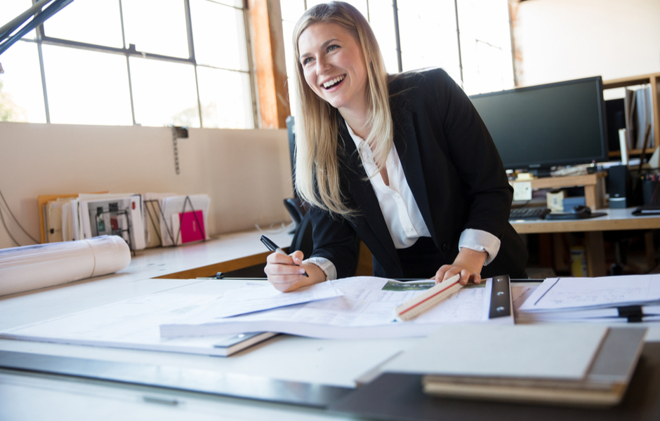 female architect standing over desk