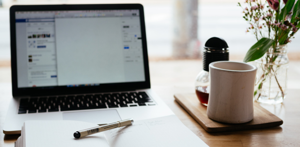 Office desk with coffee and tablet on it