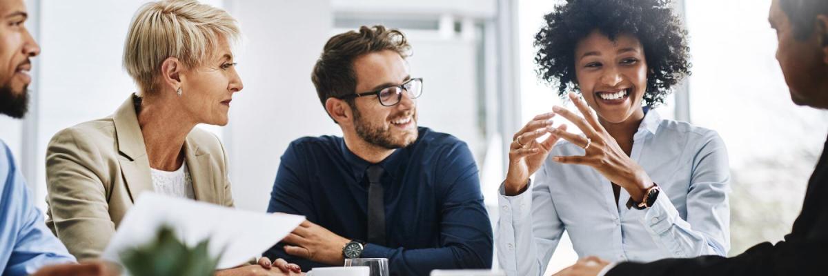  group of agreeable people sitting together in a meeting