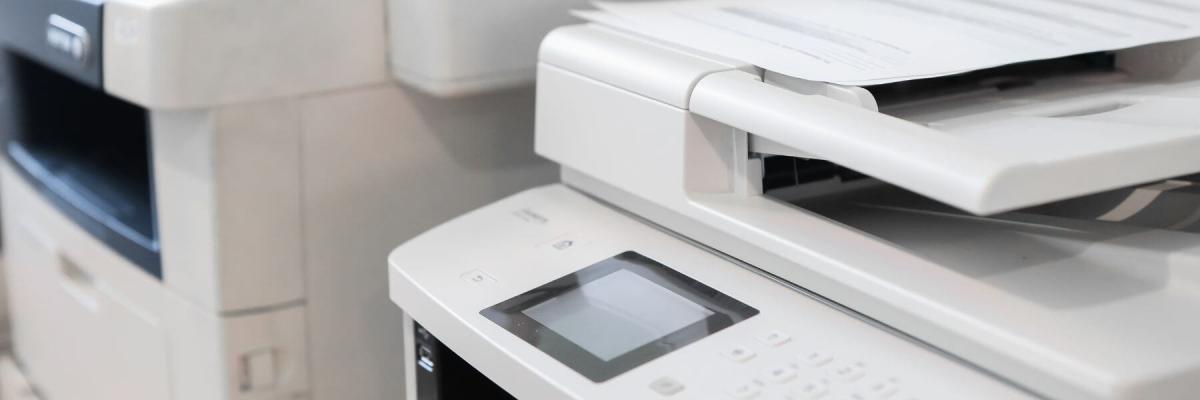 two large printers along a wall